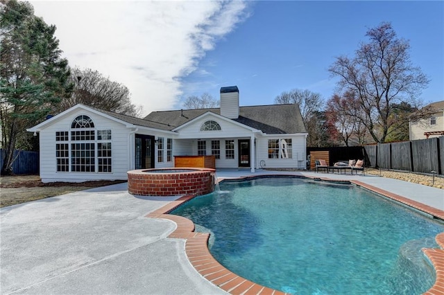 view of pool with an in ground hot tub and a patio