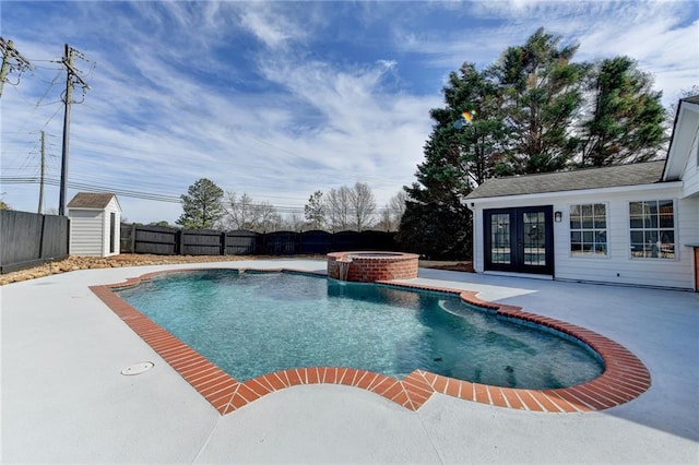 view of swimming pool featuring an in ground hot tub, a patio, a shed, and french doors