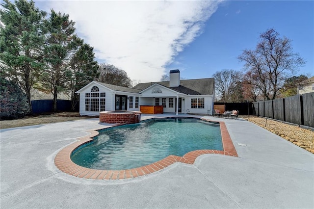 view of pool featuring a patio and an in ground hot tub