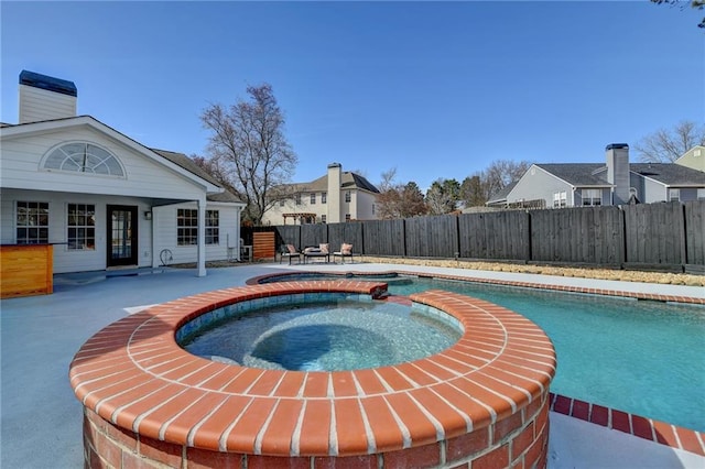 view of pool featuring an in ground hot tub and a patio area