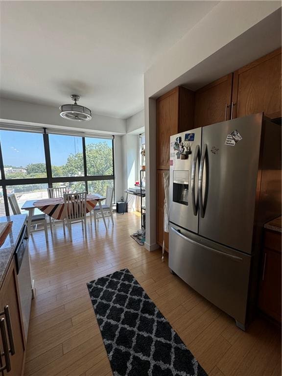 kitchen with stainless steel appliances and light hardwood / wood-style floors