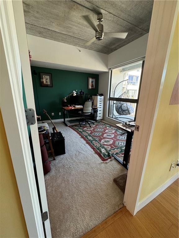 interior space with ceiling fan and carpet