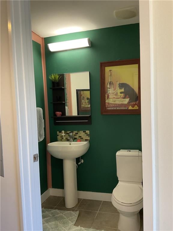 bathroom featuring toilet and tile patterned floors