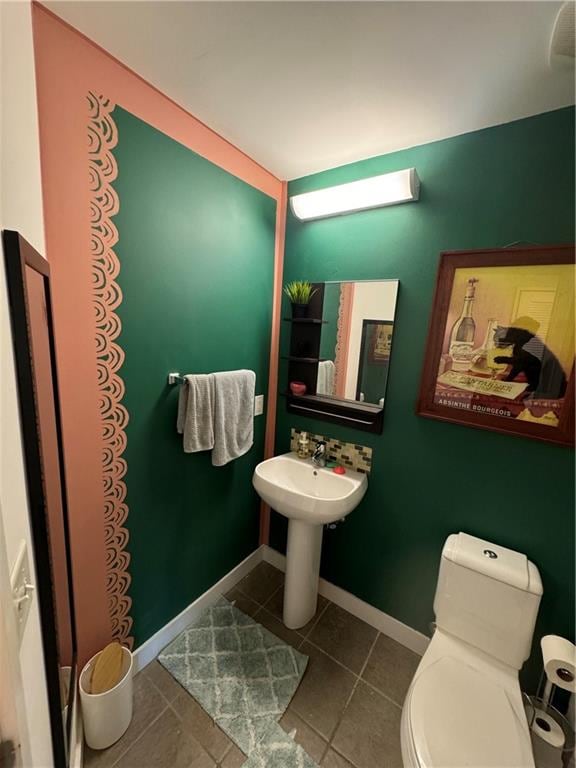 bathroom with toilet and tile patterned floors