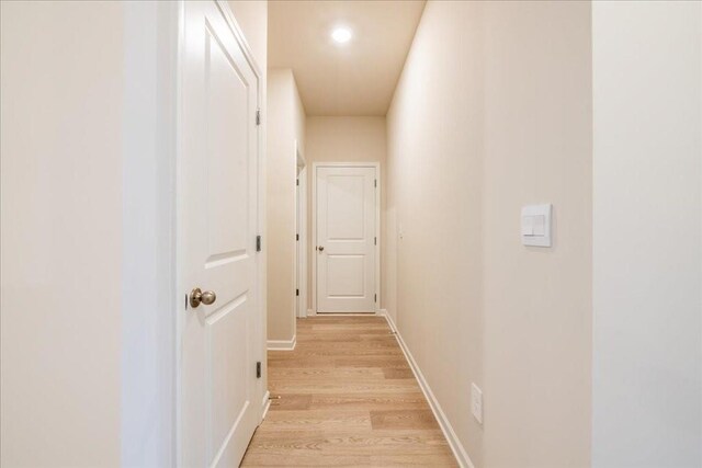 corridor with light hardwood / wood-style flooring