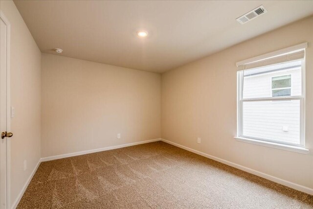 unfurnished room featuring carpet