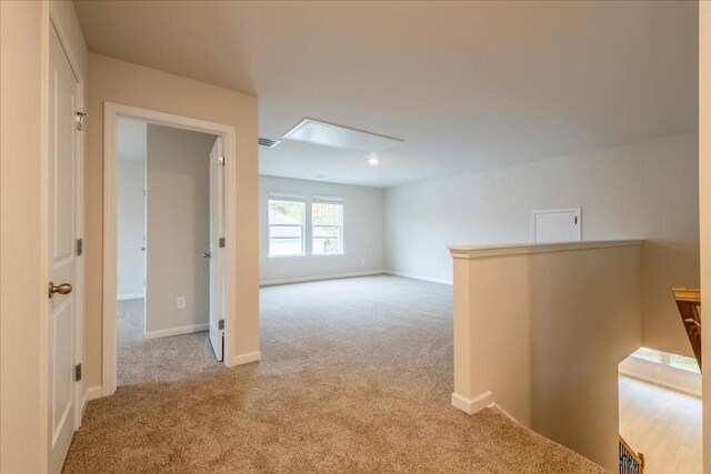 hall featuring light colored carpet