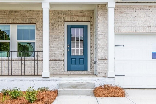 doorway to property featuring covered porch