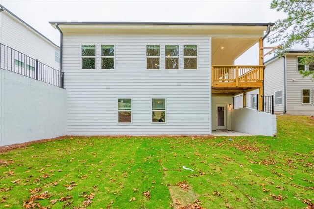 rear view of property featuring a lawn