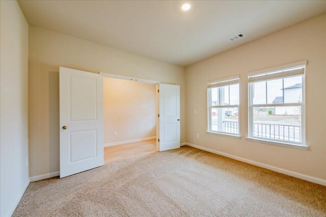 unfurnished bedroom with light carpet