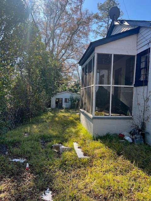 view of yard with a sunroom