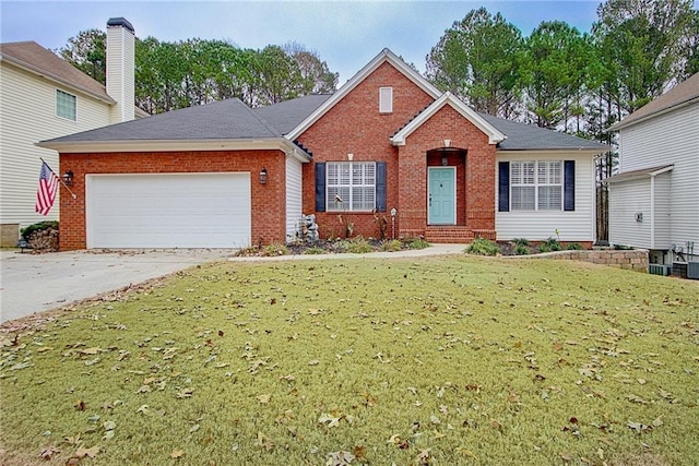 view of front of house with a garage and a front lawn