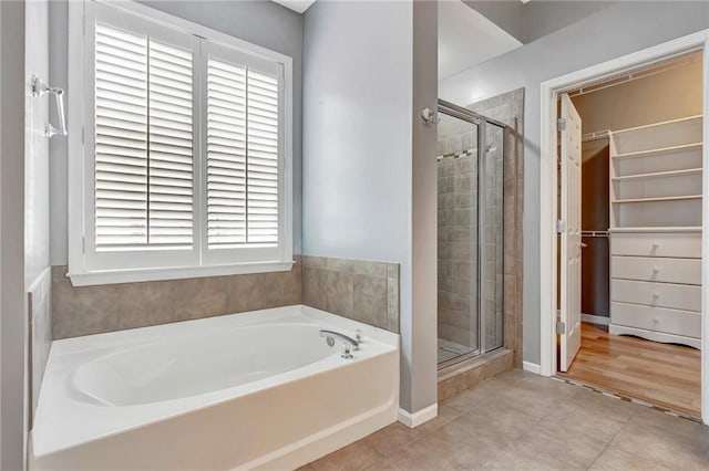 bathroom with tile patterned flooring and plus walk in shower