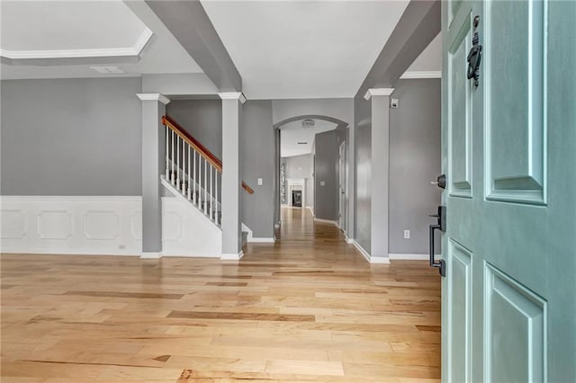 entrance foyer featuring light hardwood / wood-style floors and crown molding