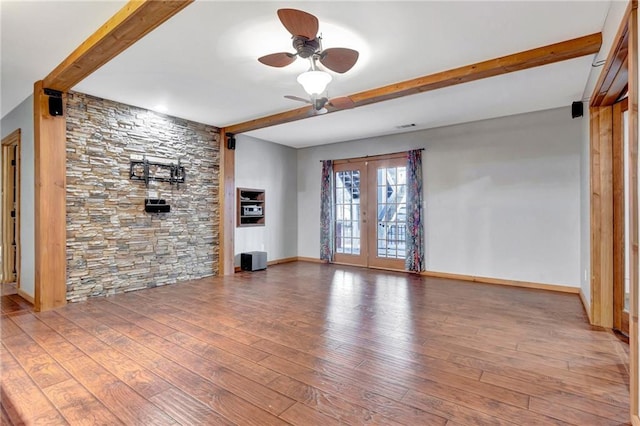 unfurnished living room featuring beamed ceiling, ceiling fan, hardwood / wood-style flooring, and french doors