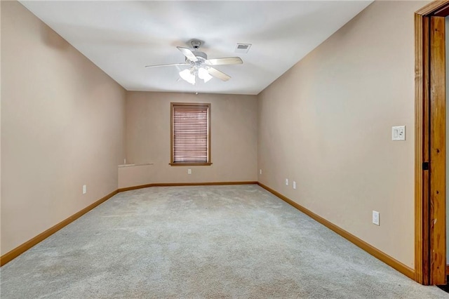 unfurnished room featuring ceiling fan and light carpet