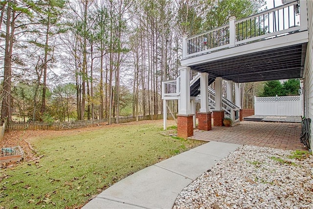 view of yard featuring a deck and a patio area