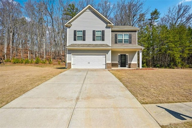 view of front of property featuring a front yard, brick siding, a garage, and driveway