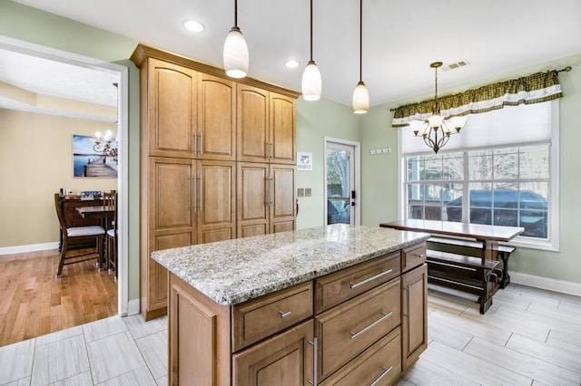 kitchen with a chandelier, pendant lighting, and a kitchen island