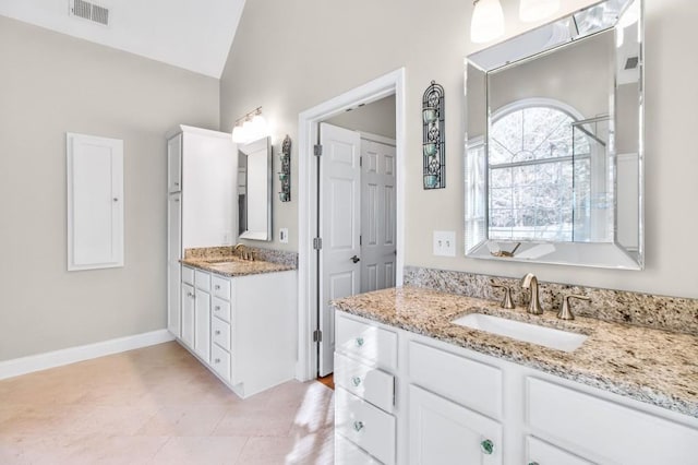 bathroom with vanity and vaulted ceiling