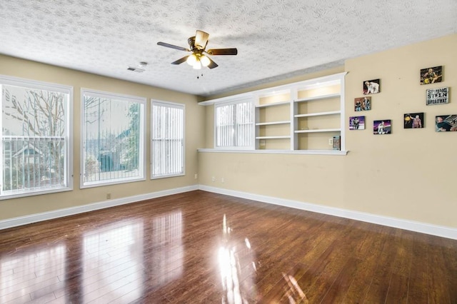 spare room featuring hardwood / wood-style floors, a textured ceiling, and ceiling fan