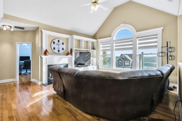 living room featuring ceiling fan, wood-type flooring, a fireplace, and lofted ceiling