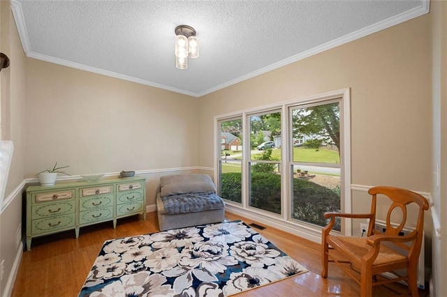 404 Pine Grove Way, Woodstock, GA 30189 - living area featuring wood finished floors, a textured ceiling, crown molding, and baseboards