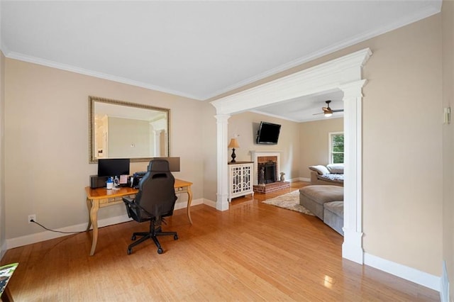404 Pine Grove Way, Woodstock, GA 30189 - office area with ornate columns, light wood-style flooring, baseboards, a brick fireplace, and ornamental molding
