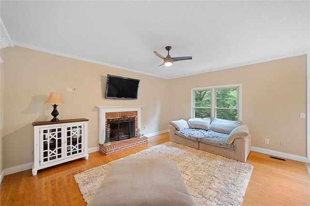 404 Pine Grove Way, Woodstock, GA 30189 - living area with ceiling fan, wood finished floors, ornamental molding, a brick fireplace, and baseboards