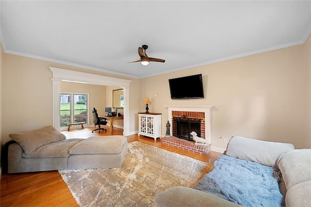 404 Pine Grove Way, Woodstock, GA 30189 - living room with ornamental molding, a ceiling fan, wood finished floors, a fireplace, and a desk