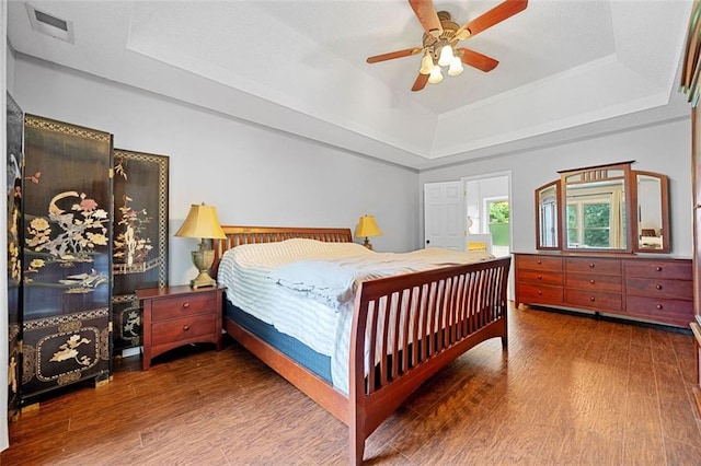 404 Pine Grove Way, Woodstock, GA 30189 - bedroom with a raised ceiling, wood finished floors, and a ceiling fan