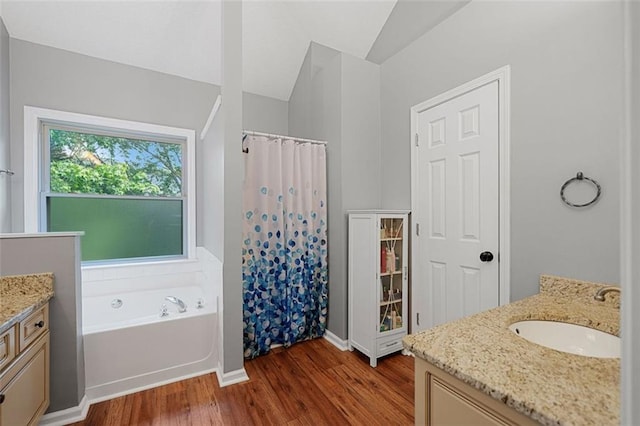 404 Pine Grove Way, Woodstock, GA 30189 - bathroom featuring vanity, wood finished floors, a garden tub, curtained shower, and baseboards