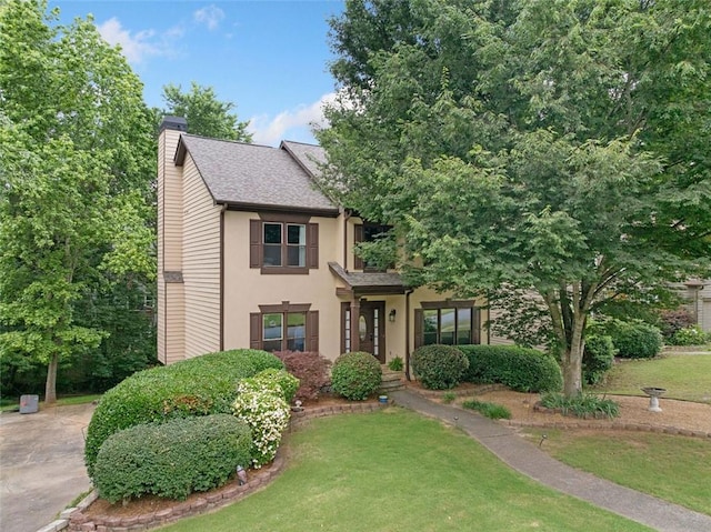 404 Pine Grove Way, Woodstock, GA 30189 - view of front of property with a chimney, a front yard, stucco siding, and a shingled roof