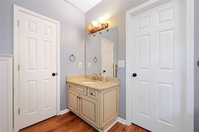 404 Pine Grove Way, Woodstock, GA 30189 - bathroom with vanity, wood finished floors, and baseboards