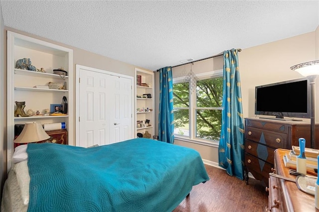 404 Pine Grove Way, Woodstock, GA 30189 - bedroom featuring a textured ceiling, wood finished floors, and a closet