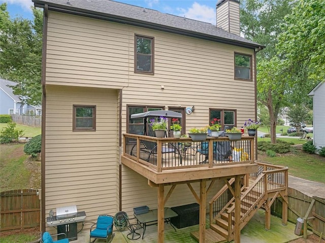 404 Pine Grove Way, Woodstock, GA 30189 - back of property with a deck, a chimney, and a shingled roof