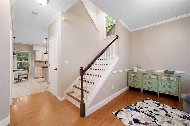404 Pine Grove Way, Woodstock, GA 30189 - stairs with wood finished floors, ornamental molding, baseboards, and a textured ceiling