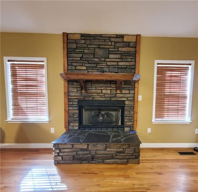 details with hardwood / wood-style floors and a fireplace