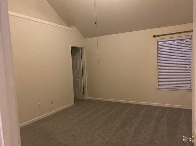 carpeted spare room with high vaulted ceiling