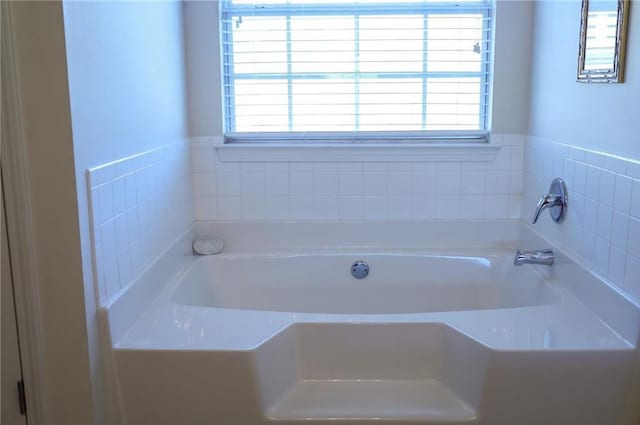 bathroom featuring a washtub and plenty of natural light