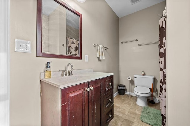 bathroom featuring vanity, tile patterned floors, and toilet