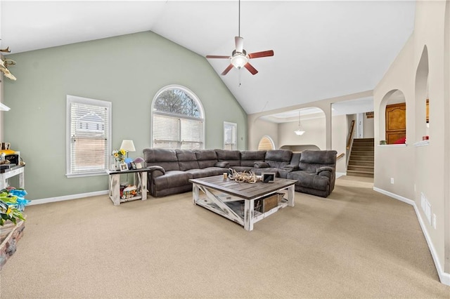 living room with ceiling fan, carpet floors, and high vaulted ceiling