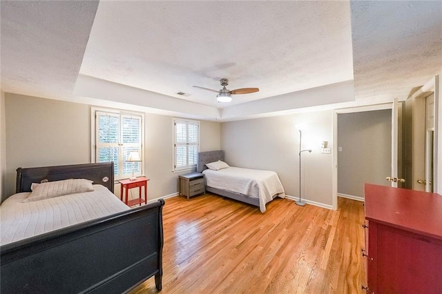 bedroom with light wood-style flooring and a textured ceiling