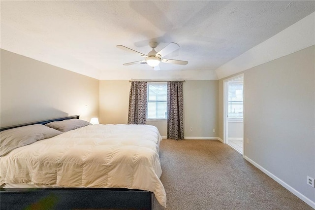 bedroom with baseboards, light colored carpet, ceiling fan, and a textured ceiling