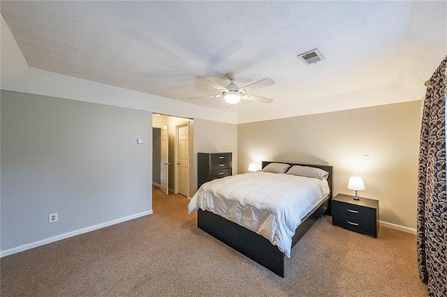 bedroom with visible vents, carpet flooring, a textured ceiling, and baseboards