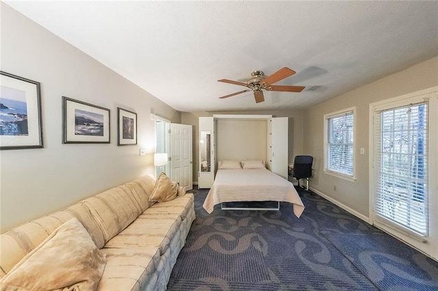 carpeted bedroom featuring access to exterior, baseboards, and ceiling fan