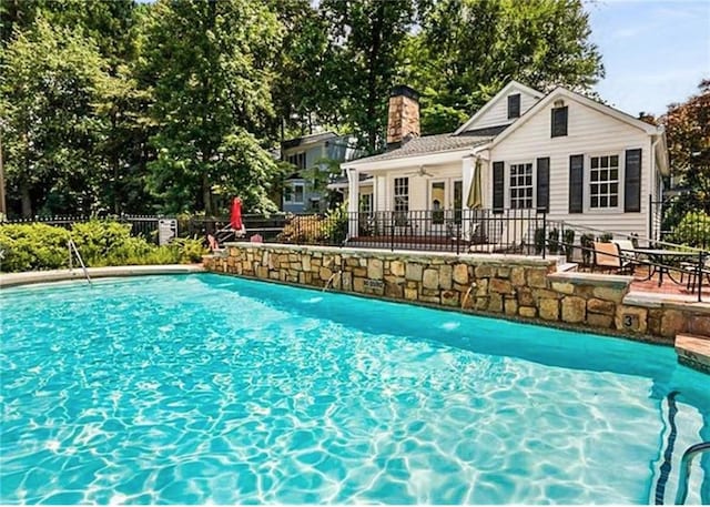 pool featuring a patio, ceiling fan, and fence