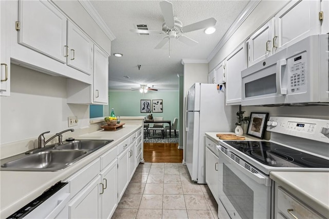 302 Ridley Howard Ct Unit 302, Decatur, GA 30030 - kitchen featuring white appliances, ceiling fan, ornamental molding, light countertops, and a textured ceiling