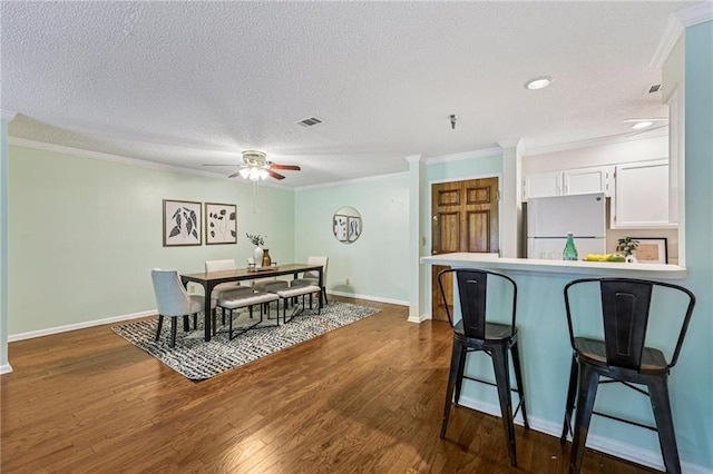 302 Ridley Howard Ct Unit 302, Decatur, GA 30030 - dining space featuring crown molding, ceiling fan, dark wood finished floors, a textured ceiling, and recessed lighting