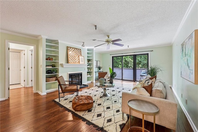 302 Ridley Howard Ct Unit 302, Decatur, GA 30030 - living area with hardwood / wood-style flooring, ornamental molding, a ceiling fan, a glass covered fireplace, and a textured ceiling